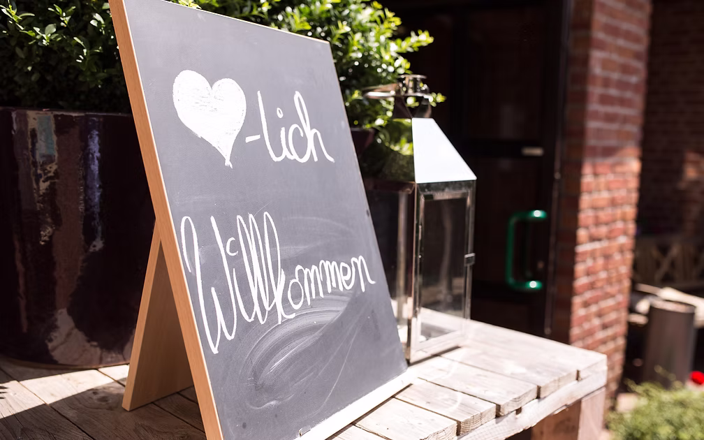 Spacious beer garden with mature trees and set tables